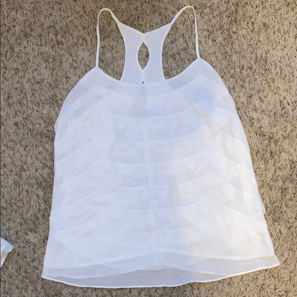Naked Zebra size medium ruffled white tank.